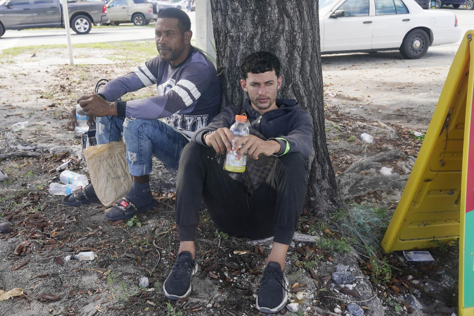 Cuban migrants wait on the side of U.S. 1 for family to picked them up after they were released from U.S. Customs and Border Protection custody Thursday, Jan. 5, 2023, in Marathon, Fla. (AP Photo/Marta Lavandier)