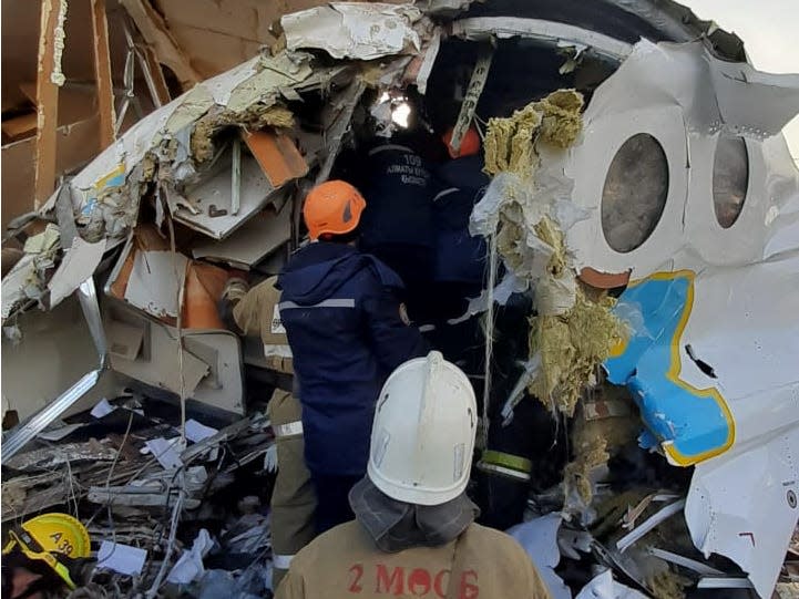 Emergency personnel work at the site of the plane crash near Almaty, Kazakhstan, December 27, 2019. Emergency Committee of Ministry of Internal Affairs of Kazakhstan/Handout via REUTERS ATTENTION EDITORS - THIS IMAGE WAS PROVIDED BY A THIRD PARTY. NO RESALES. NO ARCHIVES.