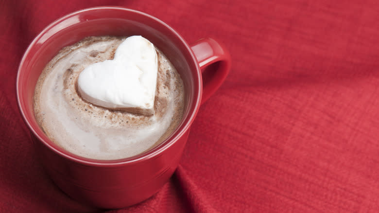 Heart-shaped marshmallow in a mug of cocoa