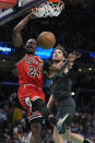 Chicago Bulls guard Javonte Green (24) dunks over Washington Wizards forward Corey Kispert, right, during the first half of an NBA basketball game Friday, April 12, 2024, in Washington. (AP Photo/Mark Schiefelbein)