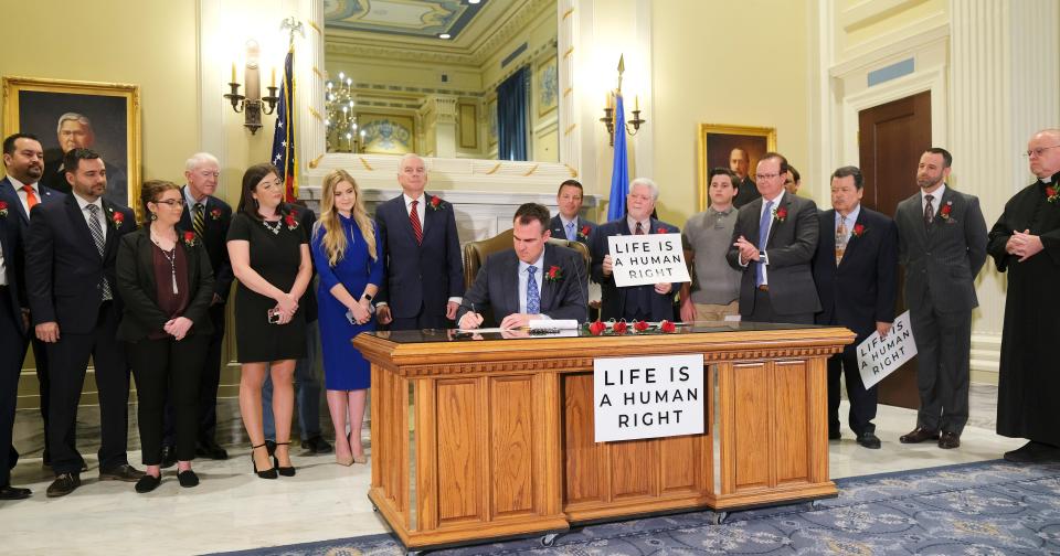 Gov. Kevin Stitt on April 12 signs Senate Bill 612 in the Blue Room at the Capitol.