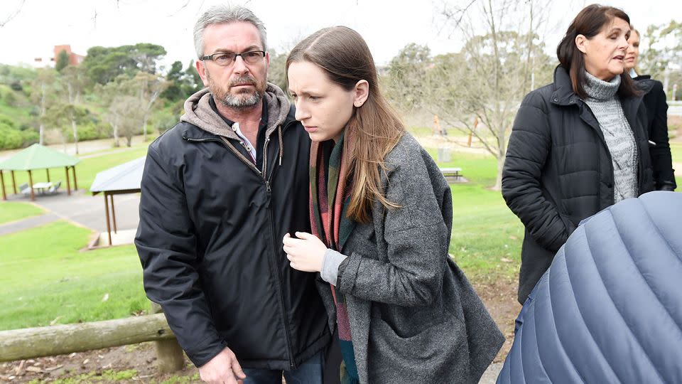 Borce Ristevski (centre right) the husband of Karen Ristevski and their daughter, Sarah, leave a press conference after pleading for information. Photo: AAP