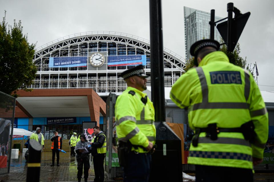 Conservative Party branded banners and police are seen outside Manchester Central convention centre, the venue of the annual Conservative Party conference, in Manchester, northwest England on September 28, 2019 on the eve of the start of the conference. - Embattled British Prime Minister Boris Johnson gathers his Conservative party Sunday for what could be its final conference before an election, and is set to be dominated by fighting talk on Brexit. (Photo by Oli SCARFF / AFP)        (Photo credit should read OLI SCARFF/AFP/Getty Images)