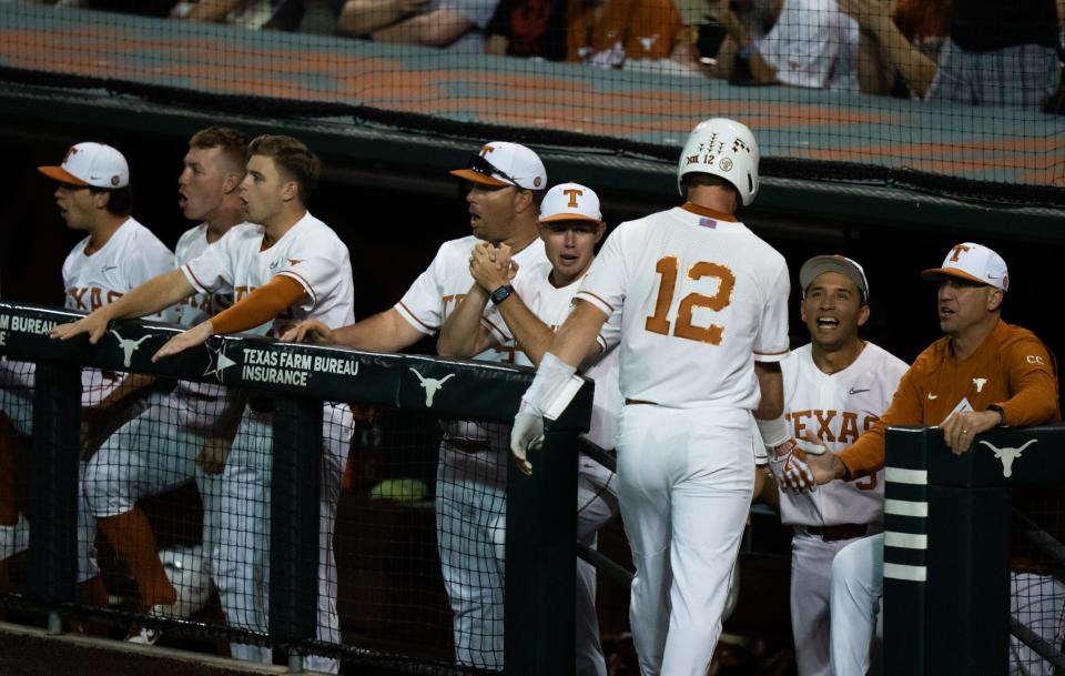 Texas outfielder Max Belyeu is welcomed by the Texas dugout after scoring a run in the fifth inning of Tuesday night's 9-3 loss to Texas State. The Longhorns open a three-game weekend series at Baylor on Friday.