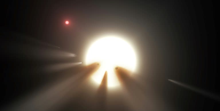 NASA image obtained January 3, 2018 shows an illustration of a star behind a shattered comet. Observations of the star KIC 8462852 by NASA's Kepler and Spitzer space telescopes suggest that its unusual light signals are likely from comet fragments