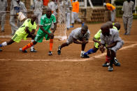 <p>Kenyan prisoners warm up before a mock World Cup soccer match between Russia and Saudi Arabia at the Kamiti Maximum Security Prison, near Nairobi, Kenya, on June 14, 2018. (Photo: Baz Ratner/Reuters) </p>