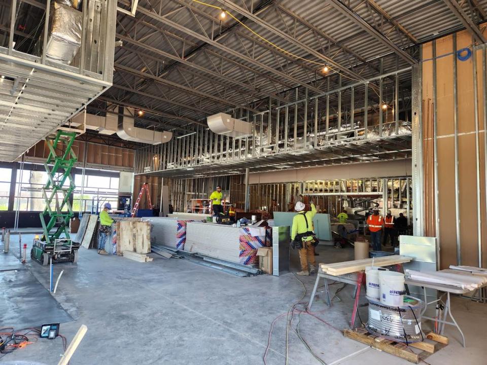 Construction workers prep the Iron Hill Brewery & Restaurant facility in the BullStreet District. It plans to open in June.