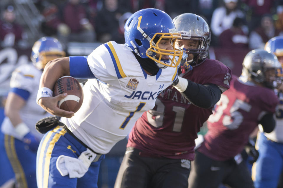 South Dakota State quarterback Taryn Christion (1) is chased down by Montana defensive end Tyrone Holmes (91) during the second half of a first-round game in the NCAA Football Championship Subdivision playoffs, Saturday, Nov. 28, 2015, in Missoula, Mont. (AP Photo/Patrick Record)