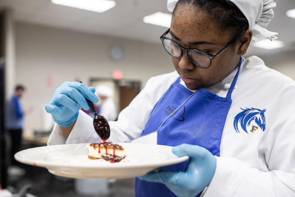 Iman Moses of Fraser High School prepares a cheesecake during Michigan ProStart program's Mise en Place Bootcamp at Sysco Detroit in Canton on Friday, Jan. 13, 2023.
