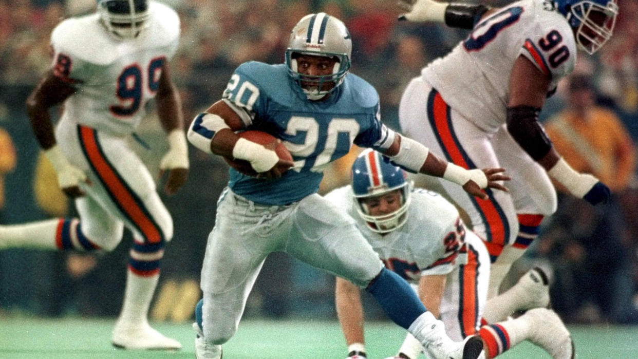 Mandatory Credit: Photo by Duane Burleson/AP/Shutterstock (6483934a)SANDERS FILE--Detroit Lions running back Barry Sanders leaves behind Denver Broncos defenders in 1990 at the Pontiac Silverdome in Pontiac, Mich.