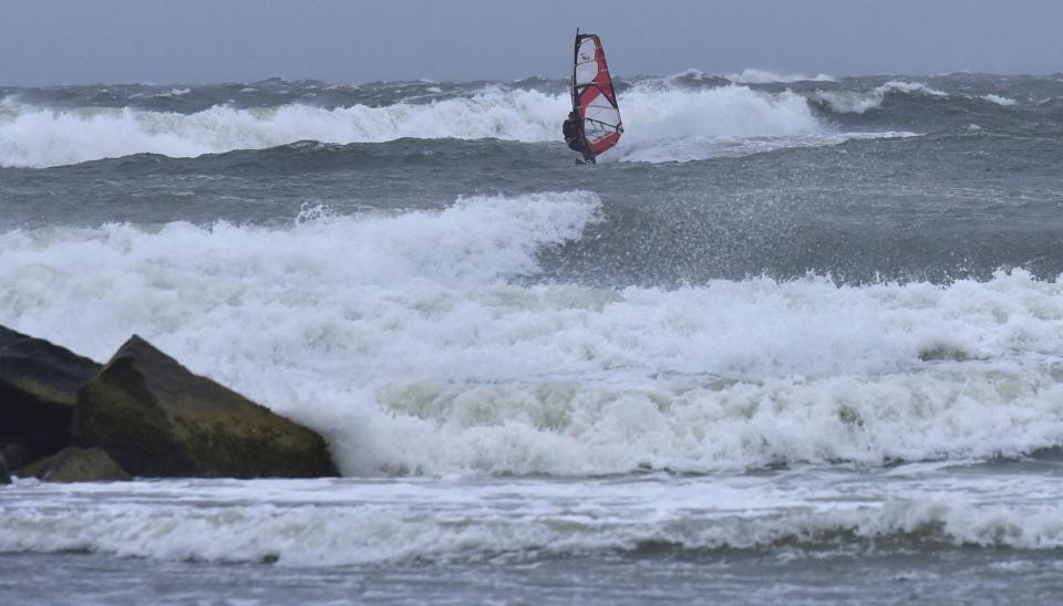 A windsurfer finds plenty of waves to ride on the incoming tide at Corporation Beach in Dennis taking advantage of tropical storm force- winds Saturday morning from Hurricane Lee.