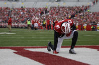 FILE - In this Nov. 9, 2019, file photo, Wisconsin's Quintez Cephus kneels before an NCAA college football game against Iowa, in Madison, Wis. Faith and family mean everything to Quintez Cephus. The junior wide receiver is enjoying the most productive season of his career at Wisconsin. But less than four months ago, football was gone, and all Cephus had was his faith and his family. (AP Photo/Aaron Gash, File)