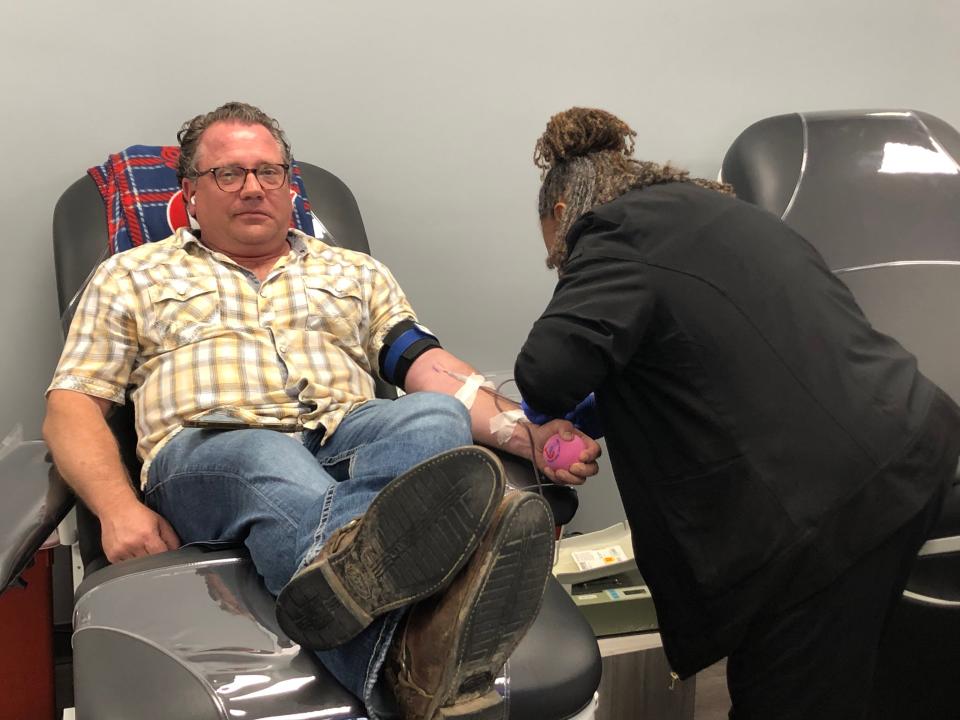 David Schmutz makes a blood donation at Blood Assurance in Nashville on May 8, 2023. Pamela Kinnard, donor care specialist, is on the right.