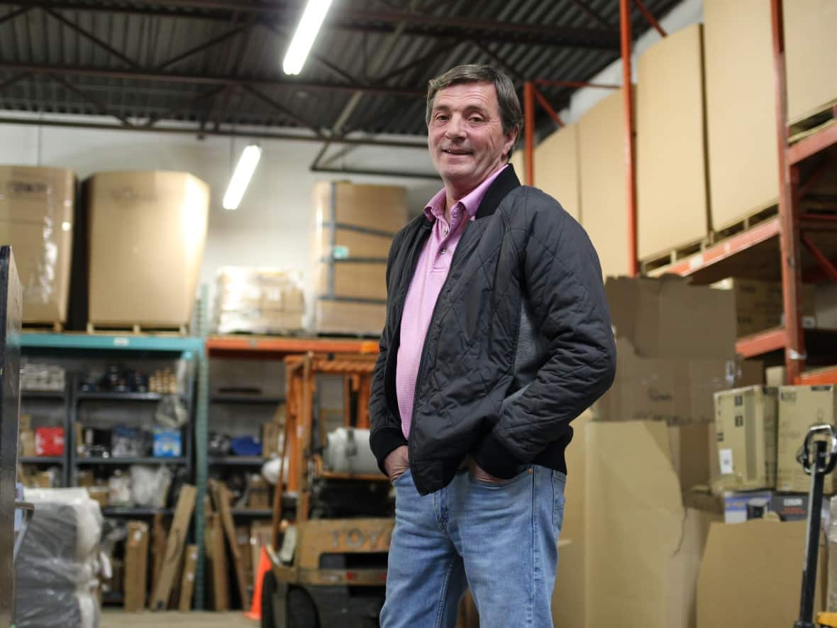 Wayne Ollive, owner of Ollive's Auction in Calgary, pictured last week, says demand for retail returns is so strong he hopes to open a second location.  (Paula Duhatschek/CBC - image credit)