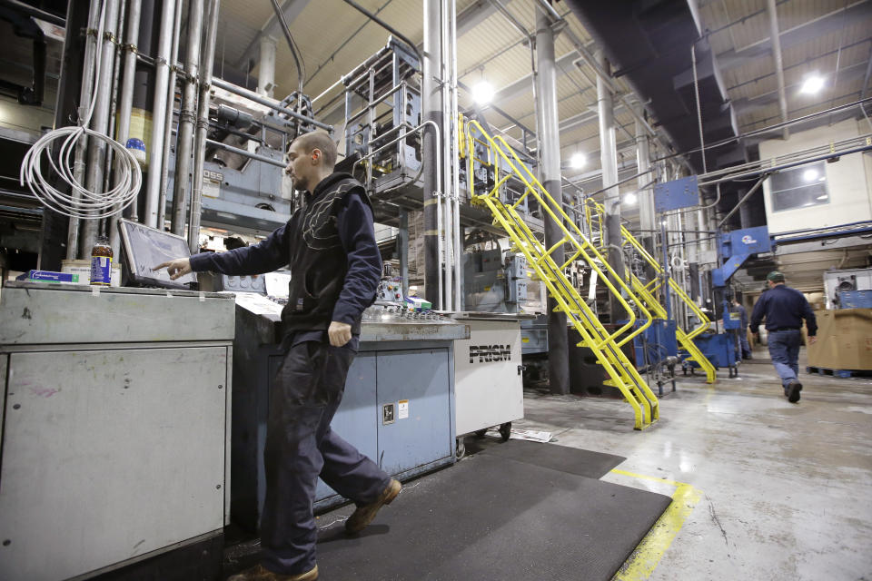 In this Thursday, April 11, 2019 photo pressman Lukus Ladeinde, of Pittsfield, Mass., left, works on the printing presses at The Berkshire Eagle newspaper, in Pittsfield. The paper now features a new 12-page lifestyle section for Sunday editions, a reconstituted editorial board, a new monthly magazine, and the newspaper print edition is wider. That level of expansion is stunning in an era where U.S. newspaper newsroom employment has shrunk by nearly half over the past 15 years. (AP Photo/Steven Senne)