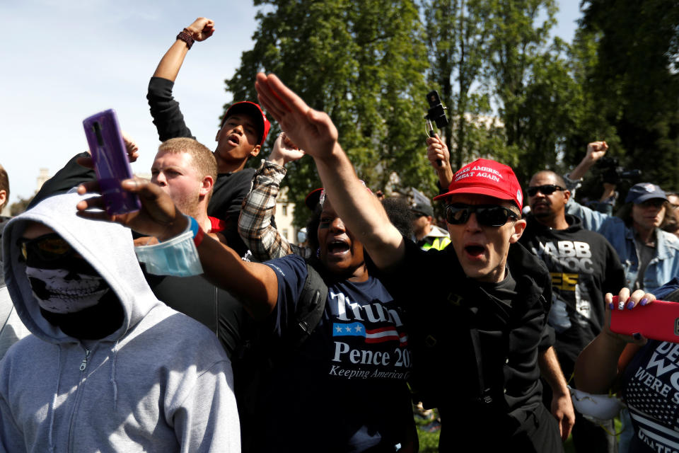 Demonstrators in support of U.S. President Donald Trump gestures during a rally in Berkeley, California in Berkeley, California, U.S., April 15, 2017. REUTERS/Stephen Lam