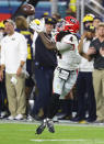 Michigan coach Jim Harbaugh, background, watches Georgia running back James Cook (4) make a touchdown reception during the fourth quarter of the NCAA College Football Playoff Orange Bowl game Friday, Dec. 31, 2021, in Miami Gardens, Fla. (Curtis Compton/Atlanta Journal-Constitution via AP)