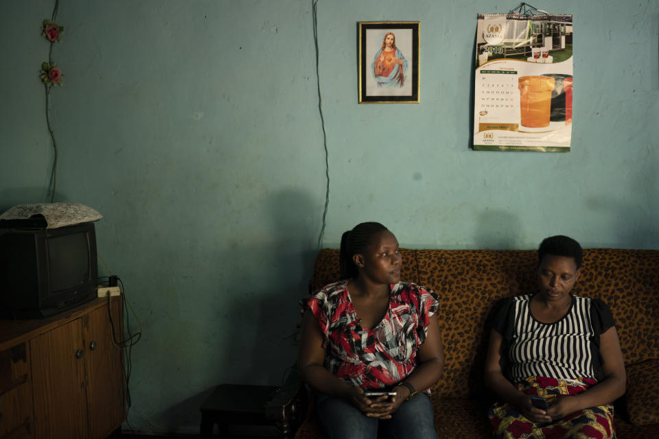 In this Sept. 9, 2019 photo, community health aide Leonie Mfitumukiza, left, asks questions to Alphonsine Umurerwa about the death of her daughter Sandrine during a "verbal autopsy" in her home in Kigali, Rwanda. The verbal autopsies now being done in Rwanda rely upon tools developed by Bloomberg Data for Health and approved by the WHO. The same toolset is also being deployed in pilot programs in Tanzania, Zambia, Myanmar, Bangladesh, and a handful of other locations. (AP Photo/Felipe Dana)