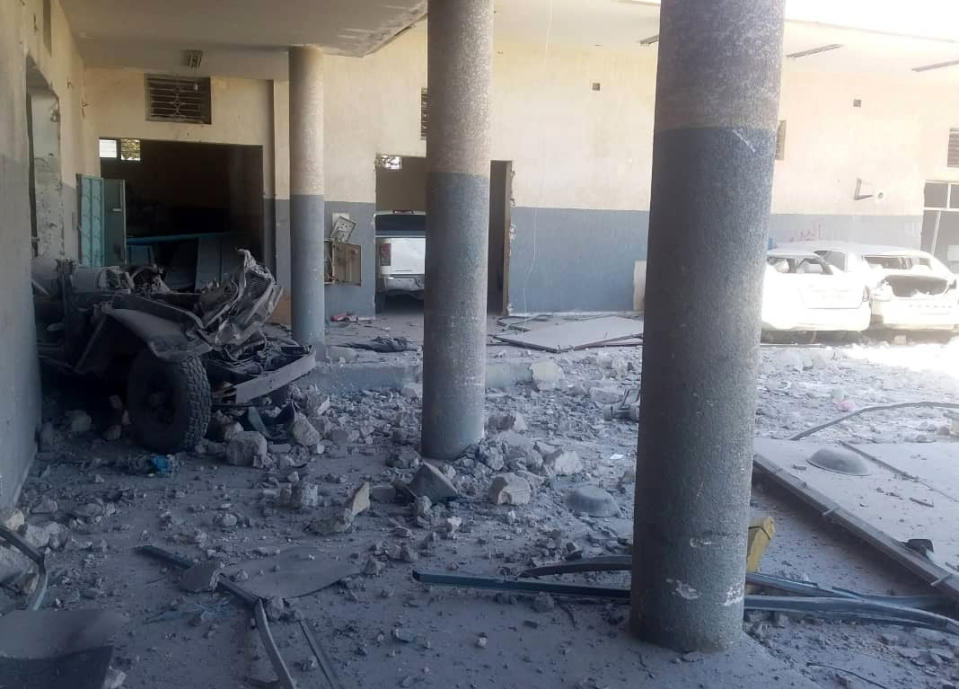 This image taken on a mobile phone on Wednesday July 3, 2019 shows the damage inside the detention center in Tripoli's Tajoura neighborhood after an airstrike. Libyan officials say an airstrike has struck a detention center for migrants in the capital, killing at least 40 people and wounding dozens. The airstrike was likely to raise further concerns about the European Union's policy of partnering with Libyan militias to prevent migrants from crossing the Mediterranean, which often leaves them at the mercy of brutal traffickers or stranded in squalid detention centers near the front lines. (AP Photo)