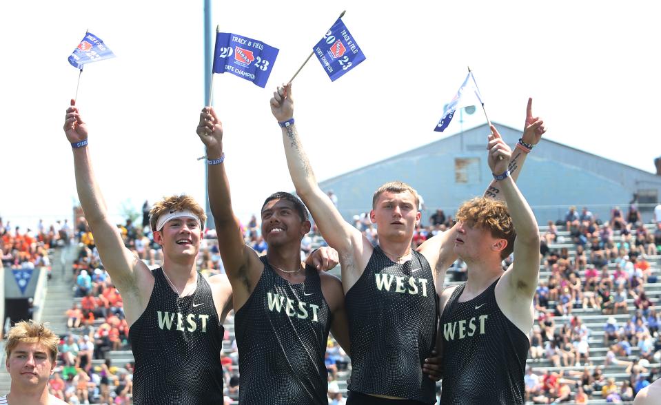 Iowa City West's Aidan Jacobsen (left) pictured with teammates Jesus Marungo-Murillo, Quinn Abbott, and Christian Janis after winning the 4A boys 110-meter shuttle hurdle relay in the Iowa boys state meet at Drake Stadium on Saturday, May 20, 2023, in Des Moines, Iowa.