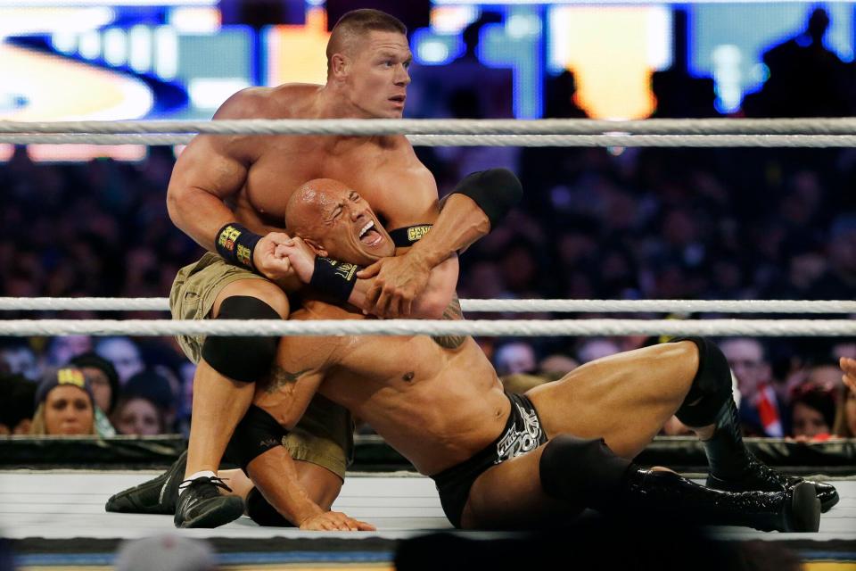 John Cena, Dwayne Douglas Johnson Wrestler John Cena, top, chokes Dwayne Douglas Johnson, known as The Rock as they wrestle during Wrestlemania, in East Rutherford, N.J. WWE bills WrestleMania as its Super Bowl, and is headed to a stadium worthy of a Super Bowl on Sunday, April 3, 2016. The WWE has lofty expectations of stuffing 100,000 fans inside AT&T Stadium in Arlington, Texas WrestleMania, East Rutherford, USA