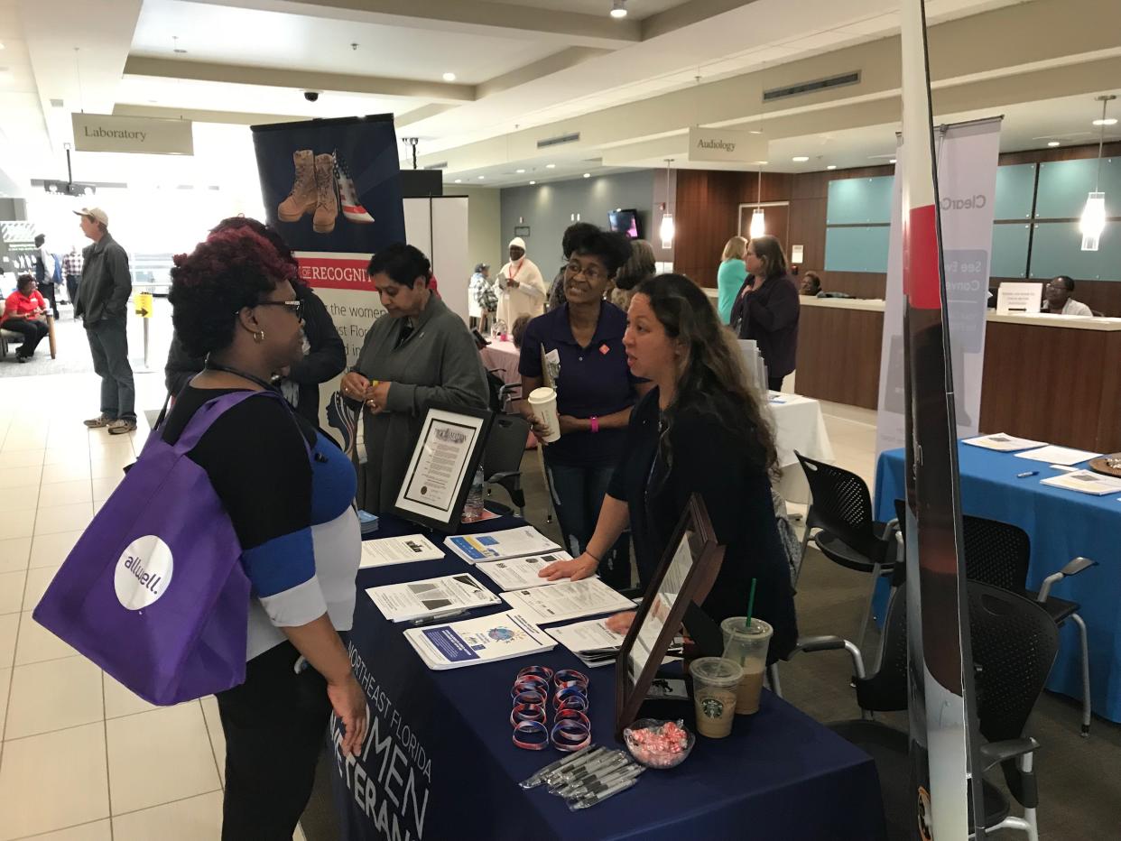 Staff from Northeast Florida Women Veterans Inc. speak with a military veteran at a 2019 mental health summit at Jacksonville's VA clinic, services that will also be highlighted at Tuesday's summit at VyStar Veterans Memorial Arena as part of Women Veterans Recognition Week.