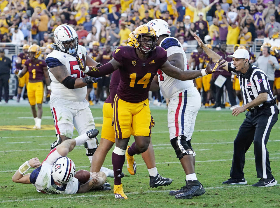 Arizona State Sun Devils defensive lineman Stanley Lambert (14) reacts after sacking Arizona Wildcats quarterback Will Plummer (15) during the 95th Territorial Cup game at Sun Devil Stadium.