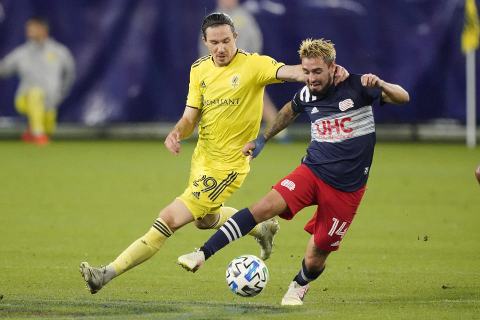 Nashville SC midfielder Alex Muyl (29) chases New England Revolution forward Diego Fagundez (14) during the first half of an MLS soccer match Friday, Oct. 23, 2020, in Nashville, Tenn. (AP Photo/Mark Humphrey)