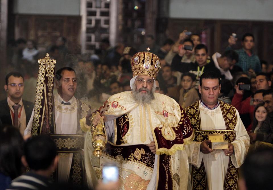 Egyptian Coptic Christians look on as Pope Tawadros II leads the Coptic Christmas Eve Mass, in Cairo