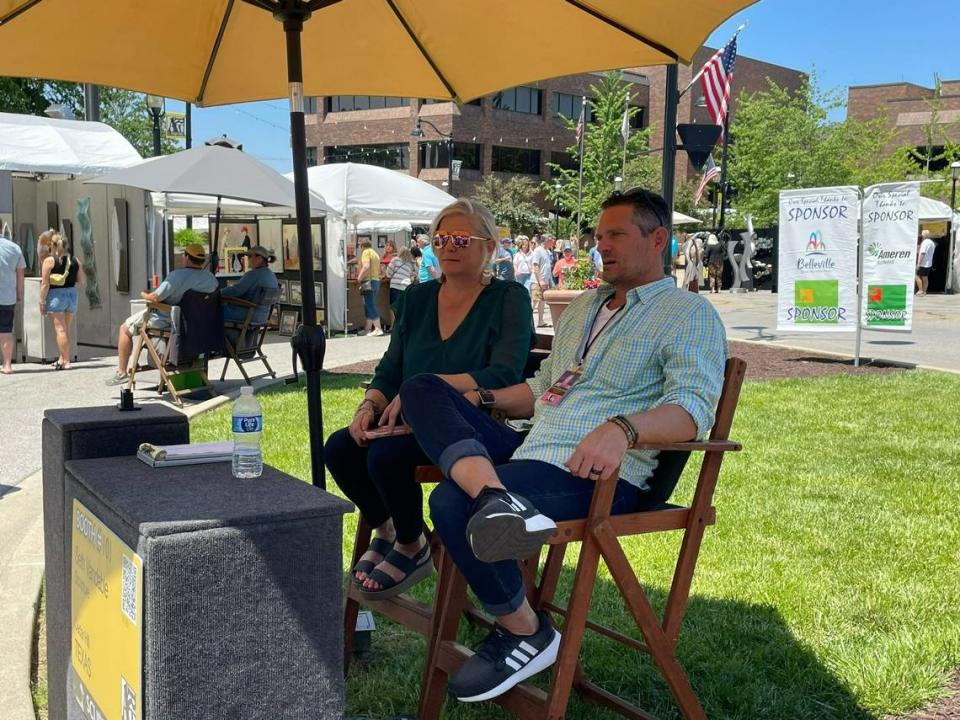 Sculptor Seth Vandable and his wife, Missy Vandable, stay cool across from his booth as people admire his Best of Show work on Sunday.