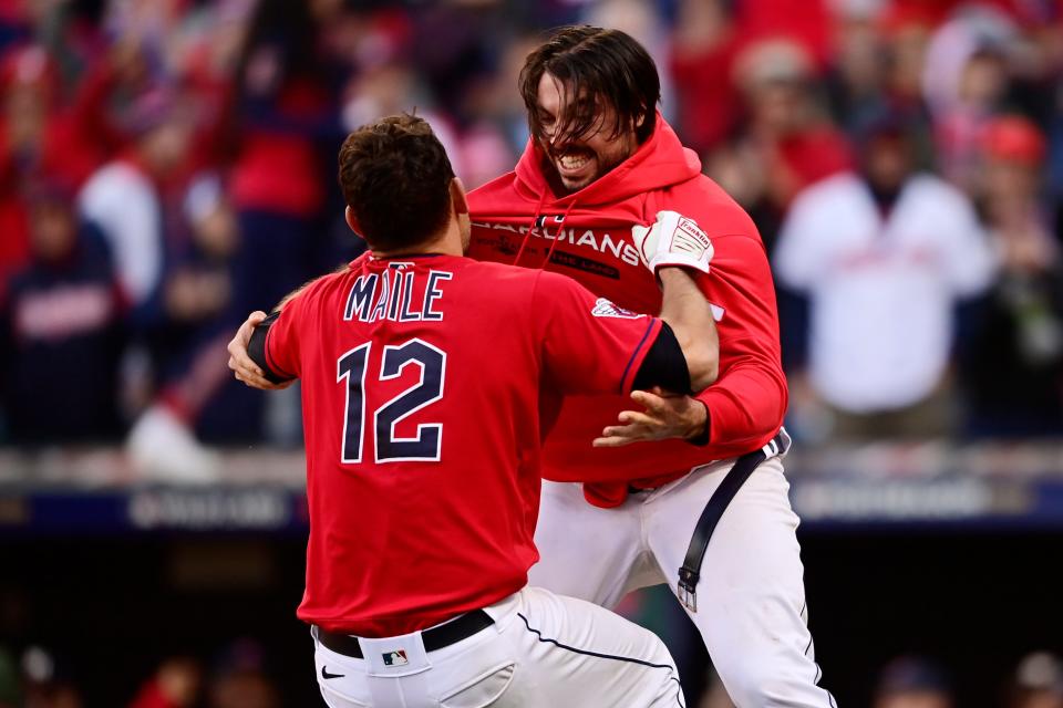 Guardians catchers Luke Maile (12) and Austin Hedges, right, celebrate after the Guardians defeated the Tampa Bay Rays 1-0  in the 15th inning of Game 2 of the wild card series against the Tampa Bay Rays, Saturday, Oct. 8, 2022, in Cleveland.