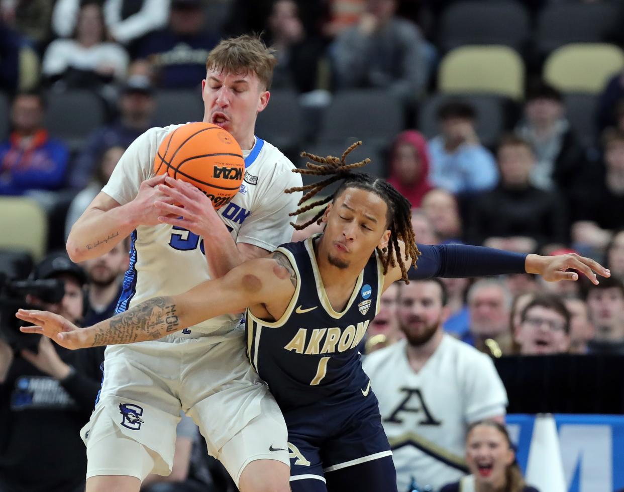 Creighton guard Baylor Scheierman, left, wins a rebound battle against Akron guard Shammah Scott during Thursday's NCAA Tournament game.