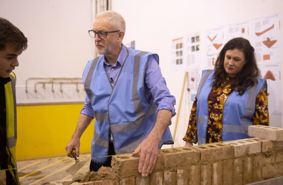 Labour Party leader Jeremy Corbyn tries his hand at bricklaying with apprentice Drew Wainwright (left) and parliamentary candidate for Ashfield Natalie Fleet (right) during a visit to the West Nottinghamshire College Construction Centre, in Ashfield, whilst on the General Election campaign trail.