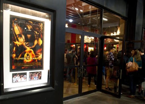 Movie goers enter the theatre for the opening of "The Hunger Games" in March 2012 at the Ziegfeld Theatre in New York. The final installment of smash hit movie franchise "The Hunger Games" is to be split into two films, the film's makers have announced