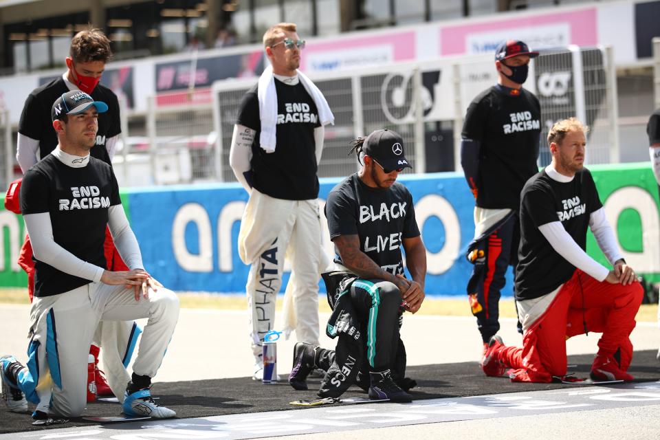 British driver Lewis Hamilton, center, kneels with other drivers before a race during the Spanish Formula One Grand Prix near Barcelona in 2020.