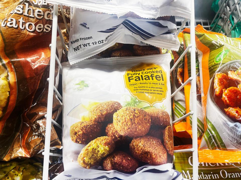 A white bag with image of falafel and a yellow label on it in the freezer section of Trader Joe's