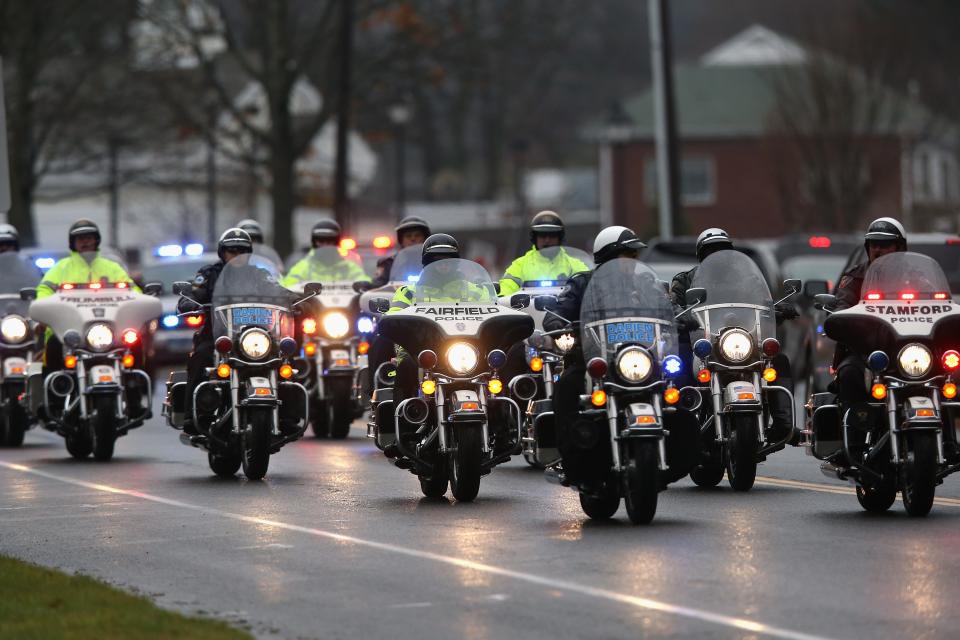 NEWTOWN, CT - DECEMBER 18: A casket carrying the body of shooting victim James Mattioli, 6, arrives for his funeral at the St. Rose of Lima Catholic church on December 18, 2012 in Newtown, Connecticut. Funeral services were held at the church for both James Mattioli and Jessica Rekos, 6, Tuesday, four days after 20 children and six adults were killed at Sandy Hook Elementary School. (Photo by John Moore/Getty Images)