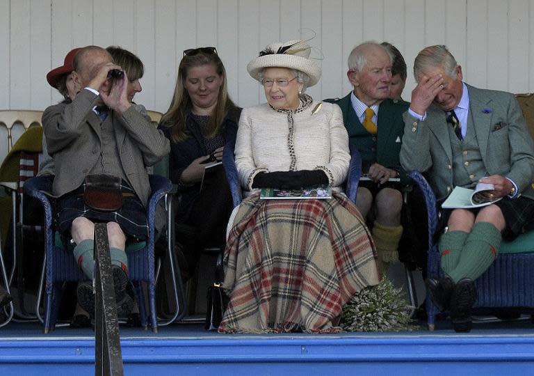 Britain's Queen Elizabeth II (C), her husband Prince Philip (L) and eldest son Prince Charles, (R) attend the Braemar Gathering in Braemar, central Scotland, on September 6, 2014