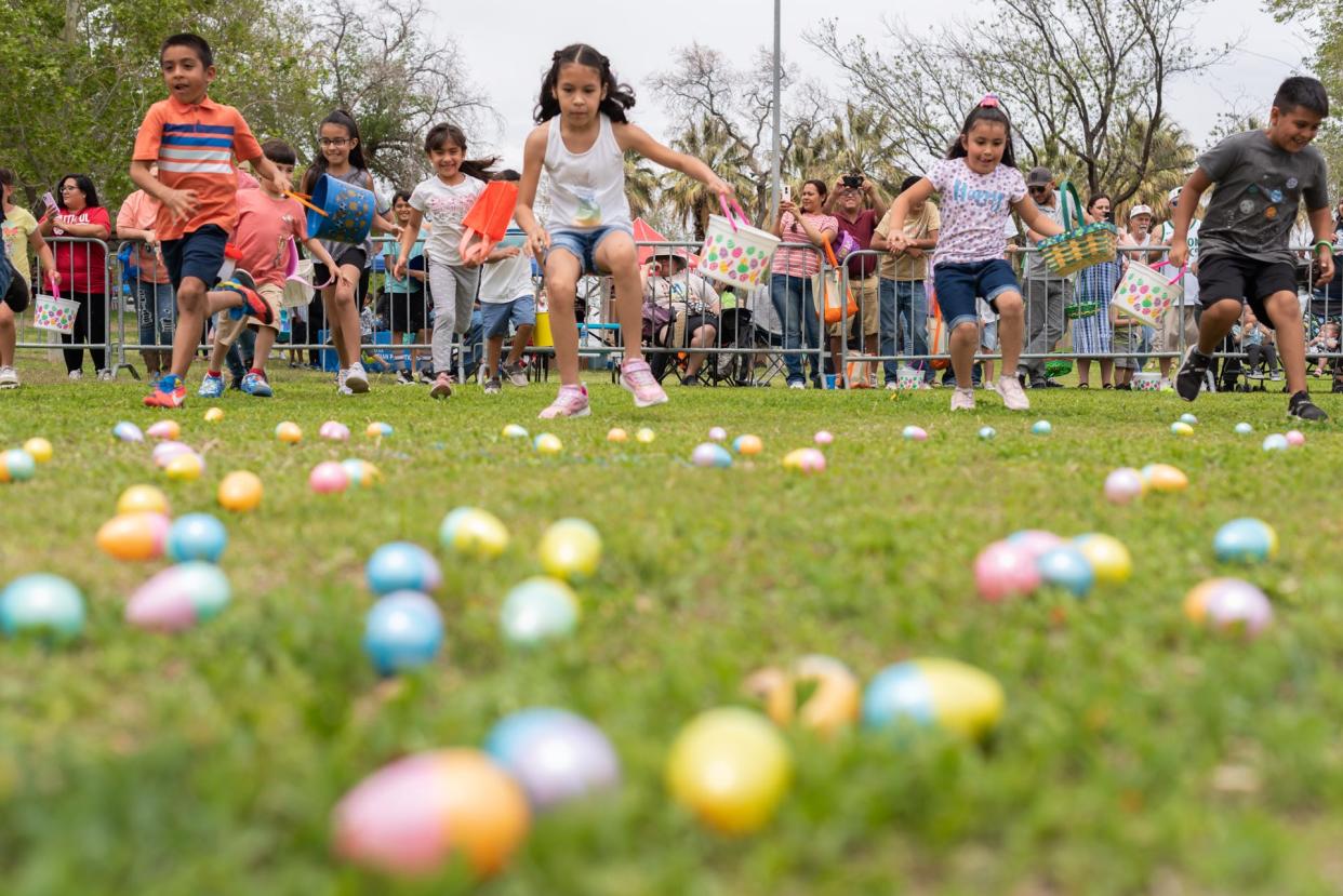 Children rush to collect eggs during the SpringFest Easter egg hunt at Young Park in Las Cruces on Saturday, April 16, 2022.