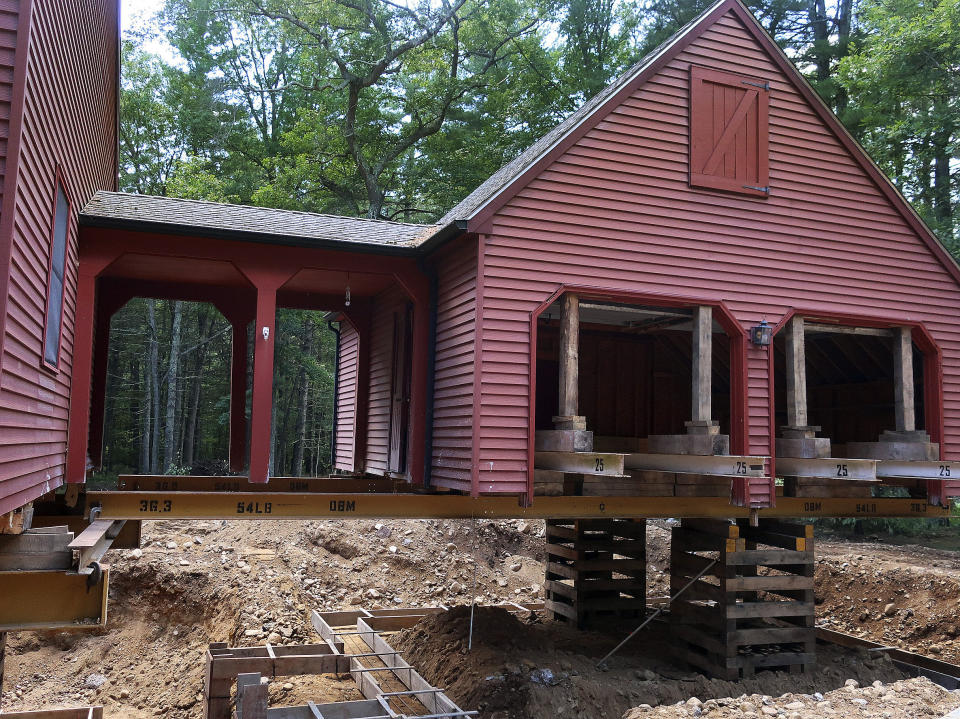 In this July 1, 2019 photo, Peter Brenn's home in Willington, Conn., sits elevated so the concrete foundation can be replace. The foundation had been deteriorating due to the presence of an iron sulfide known as pyrrhotite, often described as "a slow-moving disaster," which causes concrete to crack and break gradually as it becomes exposed to water and oxygen. After worrying for years about the foundations crumbling beneath their houses, hundreds of suburban homeowners in a large swath of eastern Connecticut are getting help from the state to salvage their properties that had been doomed by bad batches of concrete. (AP Photo/Ted Shaffrey)
