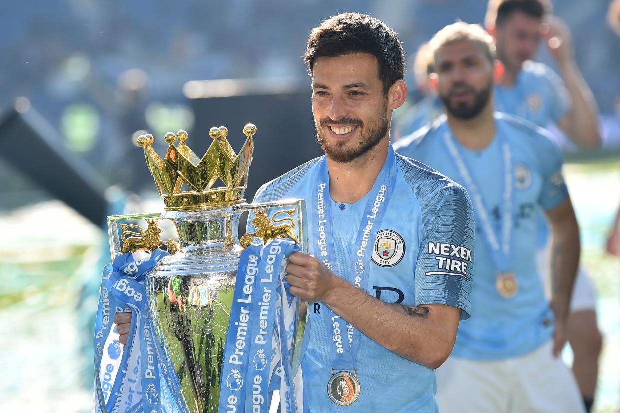 Manchester City's Spanish midfielder David Silva poses with the Premier League trophy after their 4-1 victory in the English Premier League football match between Brighton and Hove Albion and Manchester City at the American Express Community Stadium in Brighton, southern England on May 12, 2019. - Manchester City held off a titanic challenge from Liverpool to become the first side in a decade to retain the Premier League on Sunday by coming from behind to beat Brighton 4-1 on Sunday. (Photo by Glyn KIRK / AFP) / RESTRICTED TO EDITORIAL USE. No use with unauthorized audio, video, data, fixture lists, club/league logos or 'live' services. Online in-match use limited to 120 images. An additional 40 images may be used in extra time. No video emulation. Social media in-match use limited to 120 images. An additional 40 images may be used in extra time. No use in betting publications, games or single club/league/player publications. /         (Photo credit should read GLYN KIRK/AFP/Getty Images)