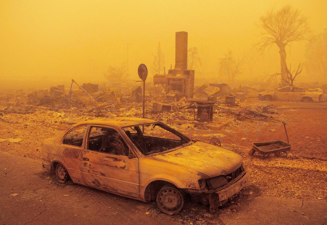 A burned residence rests in heavy smoke during the Dixie fire in Greenville, Calif. on Aug. 6, 2021.