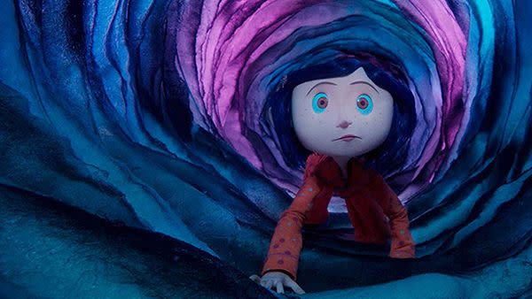 coraline crawls through a tunnel in a scene from coraline a good housekeeping pick for best scary movies for kids