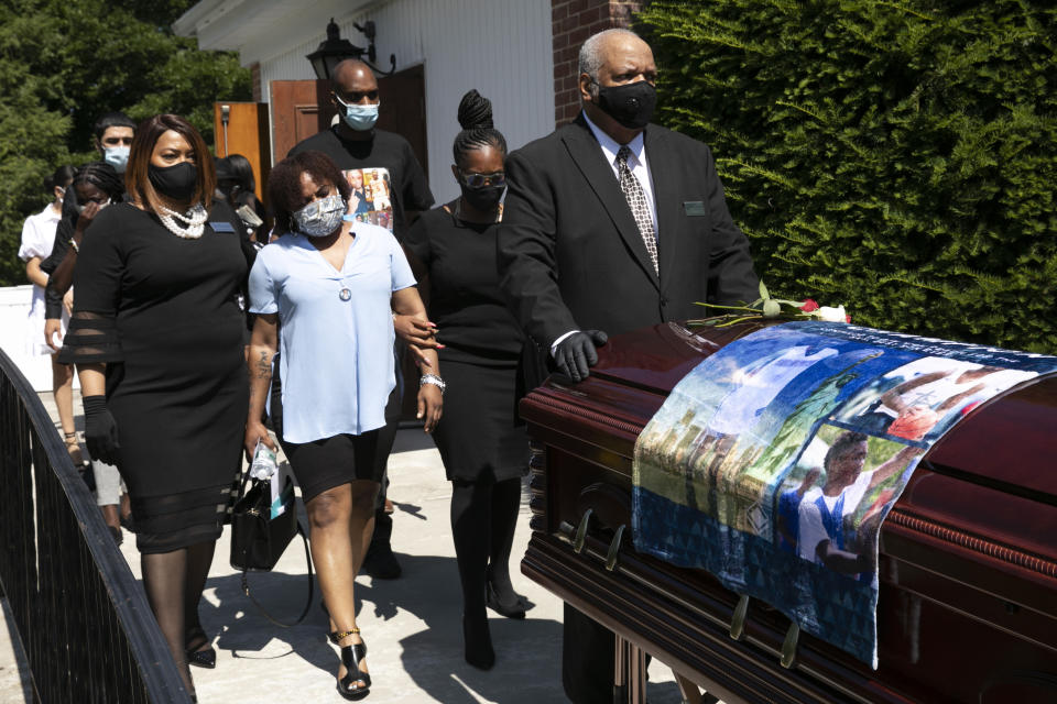 Eve Hendricks, second from left, walks behind the casket bearing her son, Brandon Hendricks-Ellison, at the First Baptist Church, Wednesday, July 15, 2020, in Bronxville, N.Y. Hendricks was shot June 29 in the Bronx two days after he graduated from James Monroe High School. The 17-year-old basketball star was one of the latest victims of gun violence across New York City. President Donald Trump is again threatening to send federal agents to New York City if local authorities don't stop a surge of violence that has left seven people dead and more than 50 people shot since Friday, Aug. 14. (AP Photo/Mark Lennihan, File)
