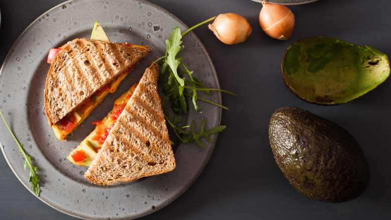 grilled cheese with avocado on plate