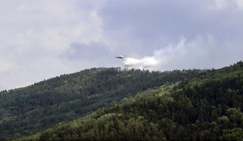 This image taken from video provided by Russian Emergency Ministry, shows a Russian Emergency Ministry's Beriev plane BE-200 Be-200 multipurpose amphibious aircraft releases water extinguishing in the Trans-Baikal National Park in Buryatia, southern Siberia, Russia, Friday, July 10, 2020. A summer heatwave across Siberia has spread the area of forestfires, with Irkutsk region northbound on Lake Baikal experiencing at least 50 fires, Russian state television reported Friday. According to Greenpeace, three million hectares of forest are currently under fire in Siberia. (Russian Emergency Ministry Press Service via AP)