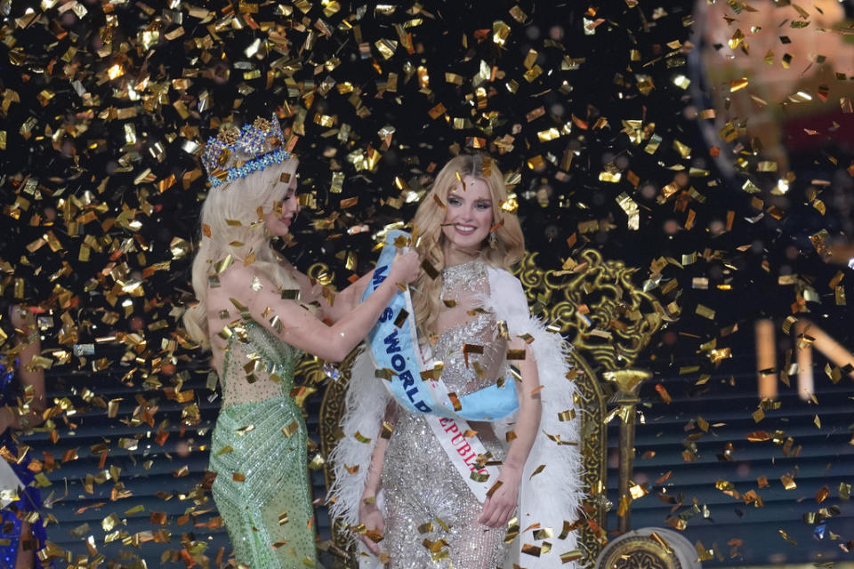 Karolina Bielawska of Poland sash her successor Krystyna Pyszková of Czech Republic after she who won the 71st Miss World pageant in Mumbai, India, Saturday, Mar. 9, 2024. (AP Photo/Rajanish Kakade)