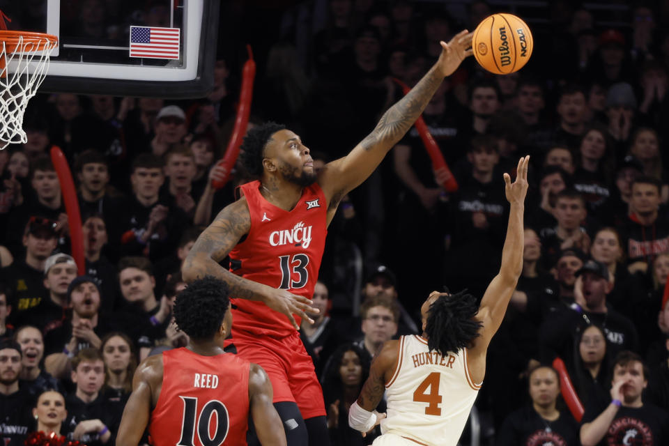 Cincinnati's Jamille Reynolds (13) blocks the shot of Texas' Tyrese Hunter during the first half of an NCAA college basketball game Tuesday, Jan. 9, 2024, in Cincinnati. (AP Photo/Jay LaPrete)