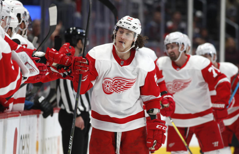 Detroit Red Wings left wing Tyler Bertuzzi is congratulated as he passes the team box after scoring a goal against the Colorado Avalanche in the first period of an NHL hockey game Monday, Jan. 20, 2020, in Denver. (AP Photo/David Zalubowski)