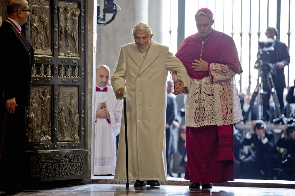 FILE - Pope Emeritus Benedict XVI enters St. Peter's Basilica accompanied by Monsignor Georg Gaenswein, right, at the Vatican, Tuesday, Dec. 8, 2015. Pope Francis met on Monday, Jan. 9, 2023, with Archbishop Gaenswein, the longtime secretary of Pope Benedict XVI who was a key figure in his recent funeral but who has raised eyebrows with an extraordinary memoir in which he settles old scores and reveals palace intrigue. (AP Photo/Andrew Medichini, File)